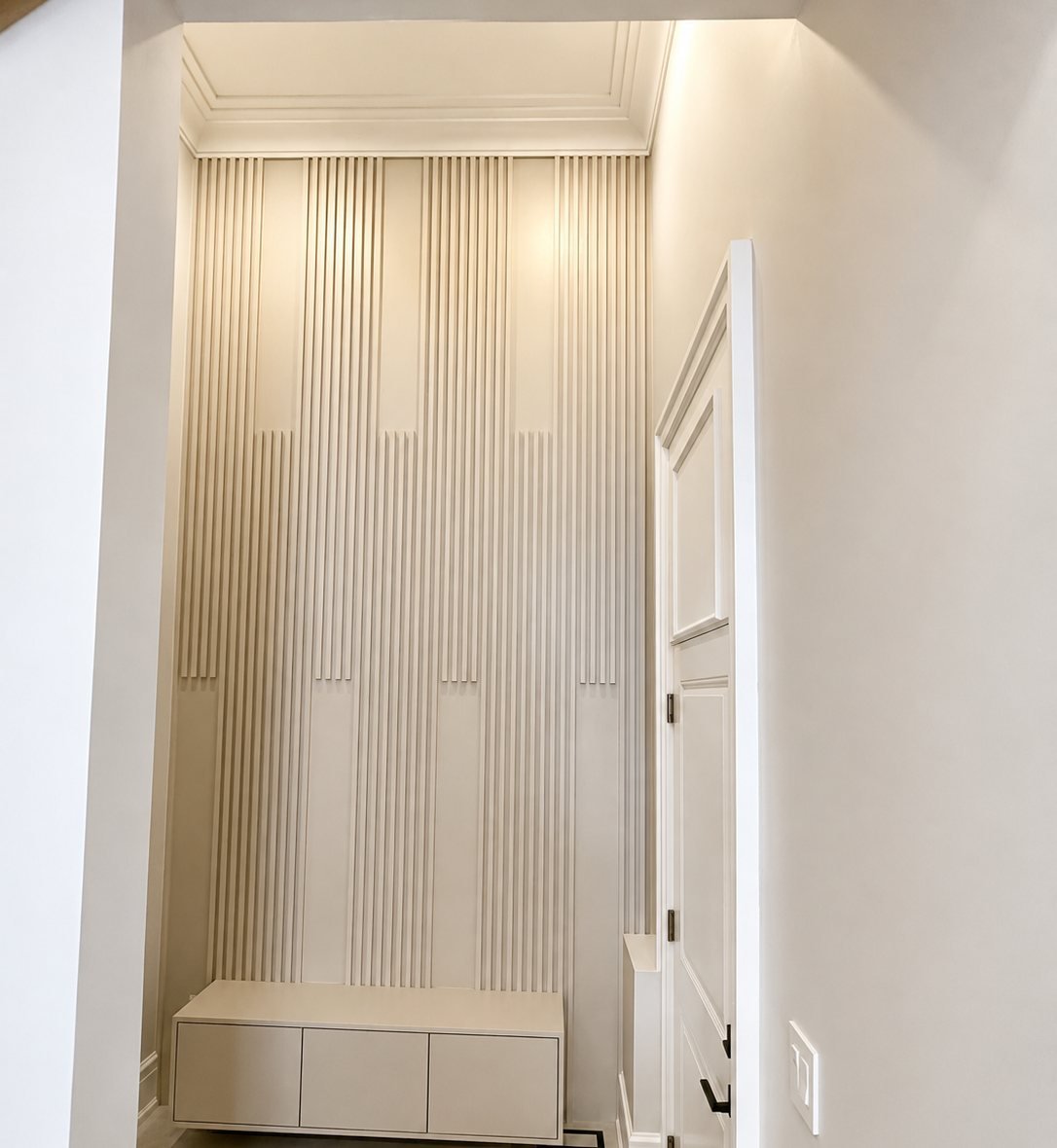 Freshly painted entry with a slat wall panel in a newer Brampton home