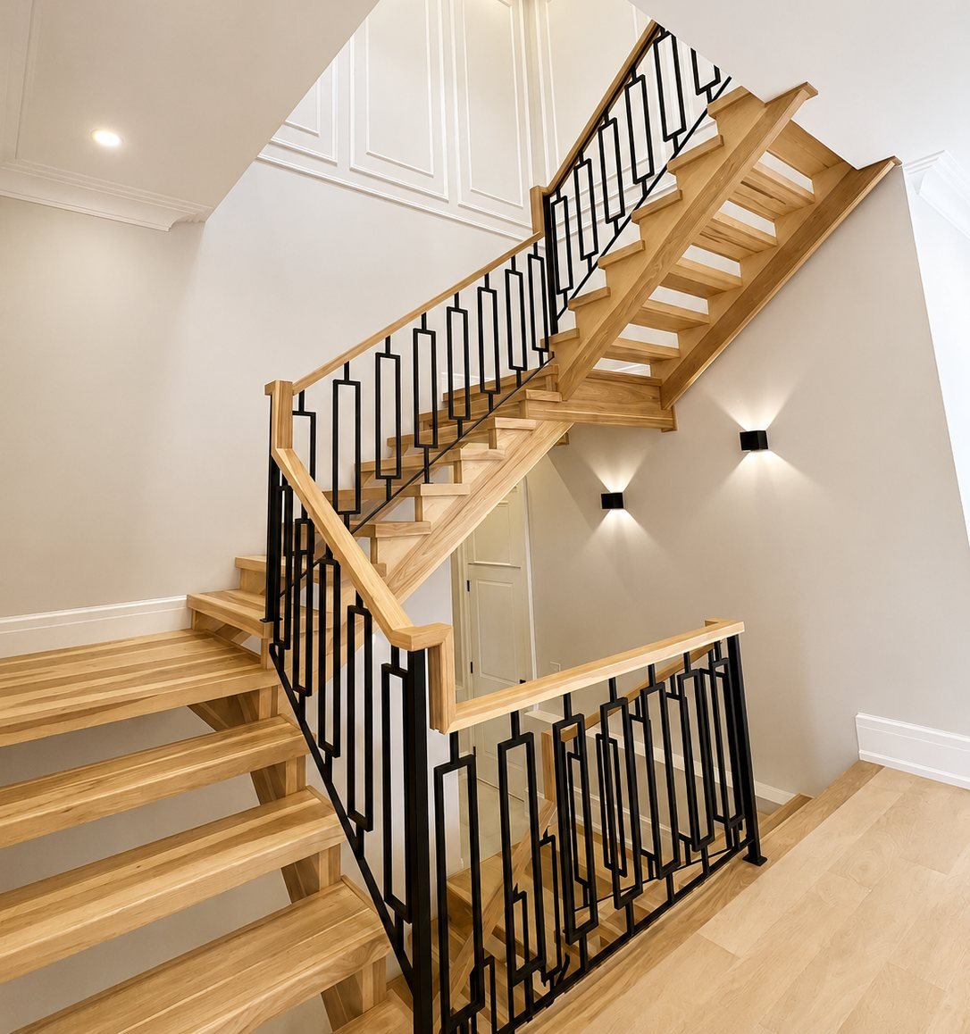 Oak staircase with a stained handrail in an Erin home