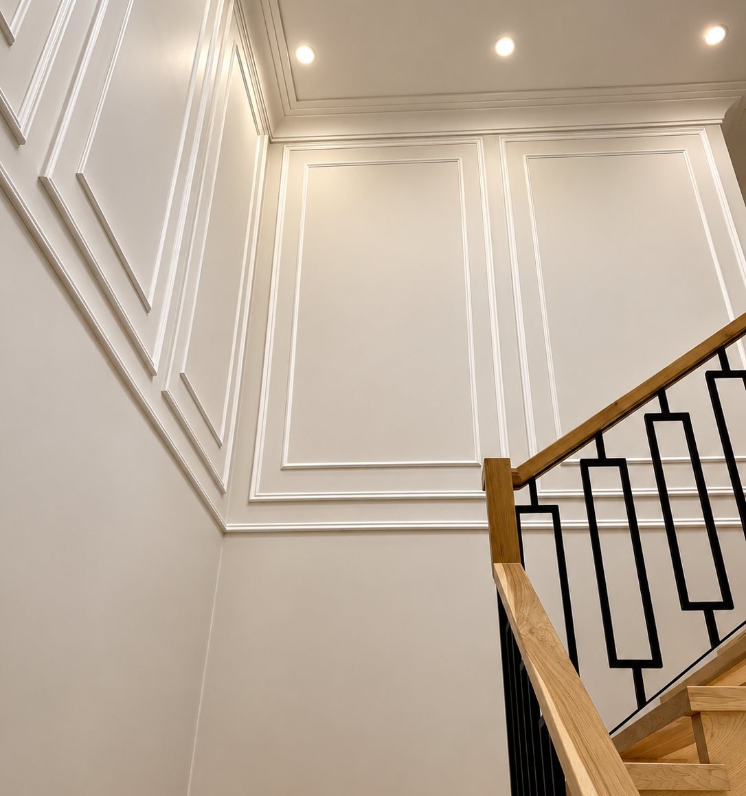 Stairwell with painted wall panel moulding in a Vaughan home