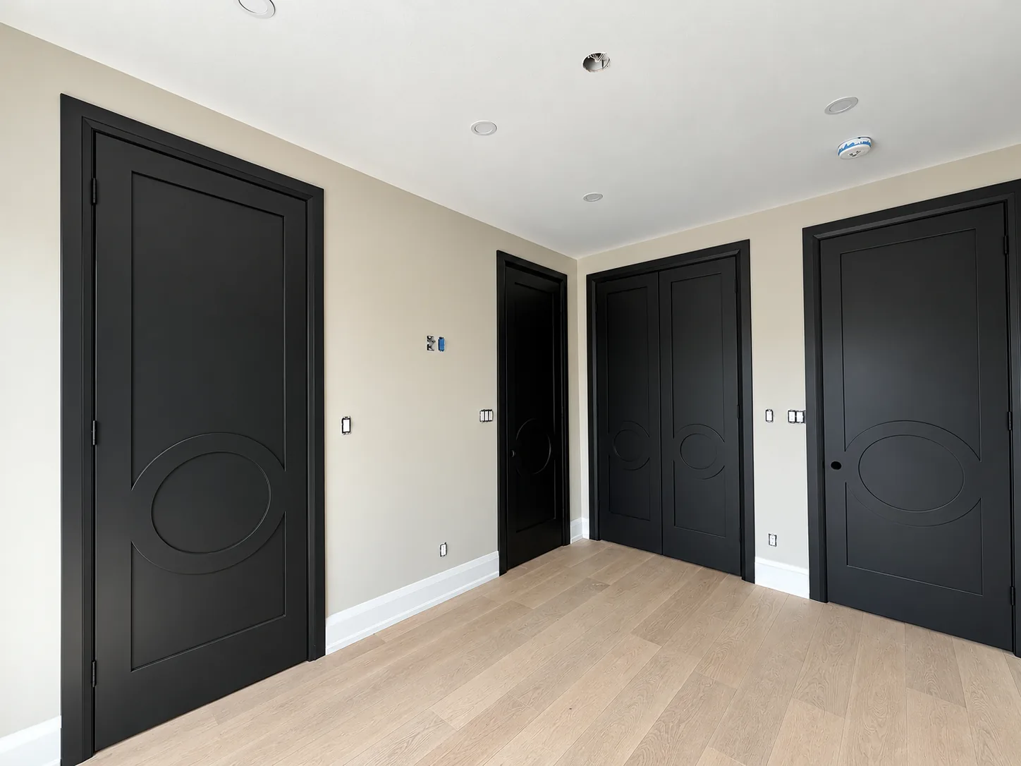 Room with black painted interior doors and neutral walls