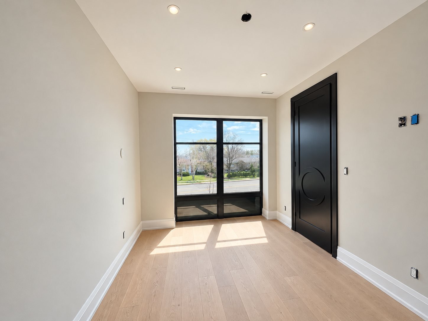 Entry with a black painted interior door and freshly painted walls
