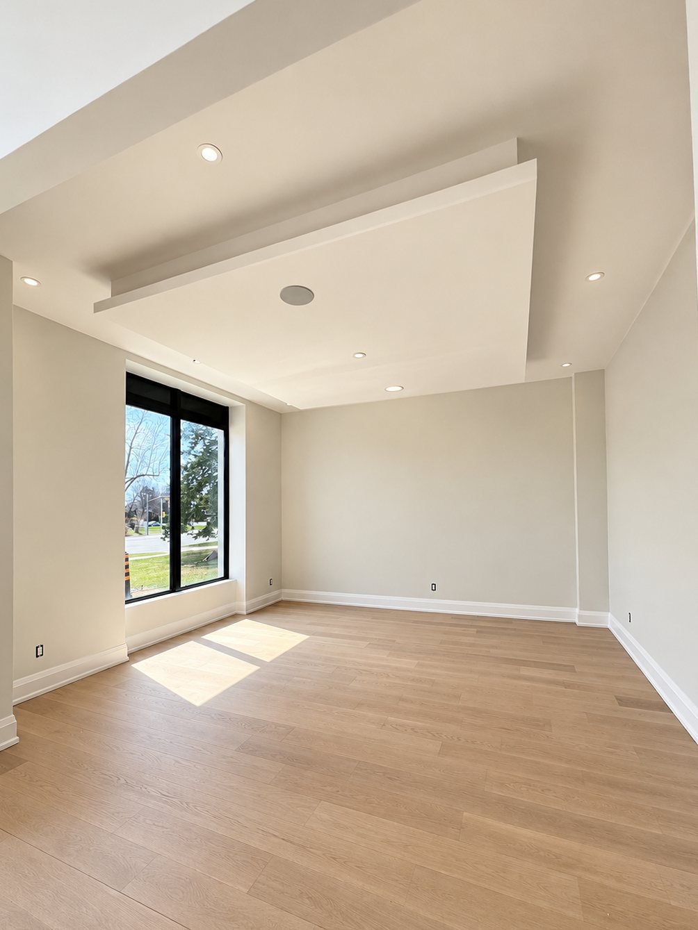 Other side of a freshly painted living room with a dropped ceiling