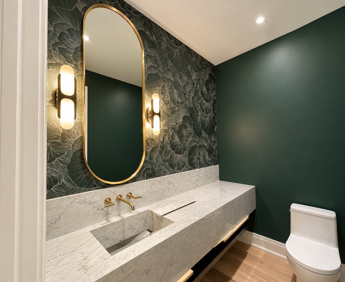 Green powder room with botanical wallpaper behind an oval mirror