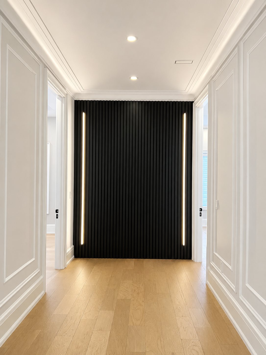 Spray-finished black wood slat wall with LED strips at the end of a hallway