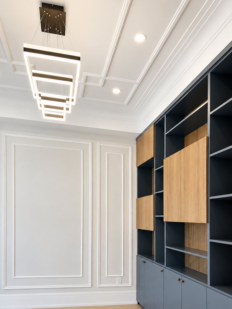 Spray-finished navy built-in cabinets with wood panels in a home office
