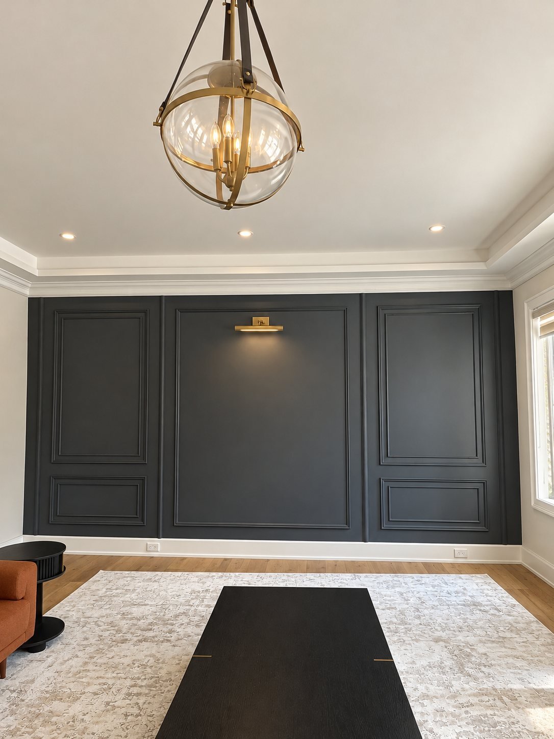Spray-finished charcoal wood panel moulding with a brass picture light